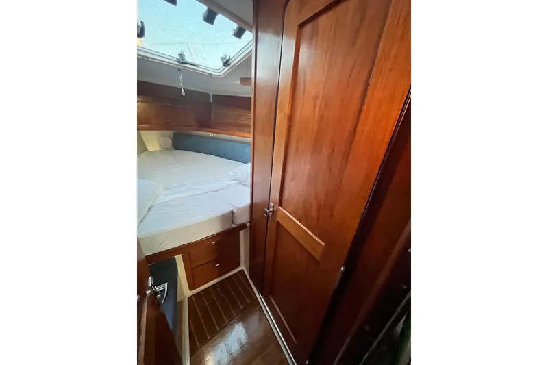 Slide: The Image of Cozy cabin interior of 1996 Catalina 400 sailboat with wooden finish and bed. - 50