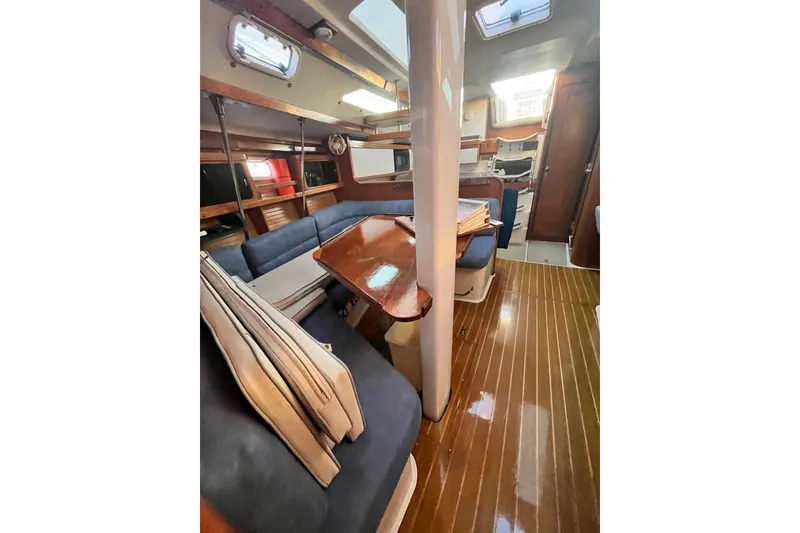 Slide: The Image of Interior of 1996 Catalina 400 sailboat with wooden flooring and cozy seating area. - 53