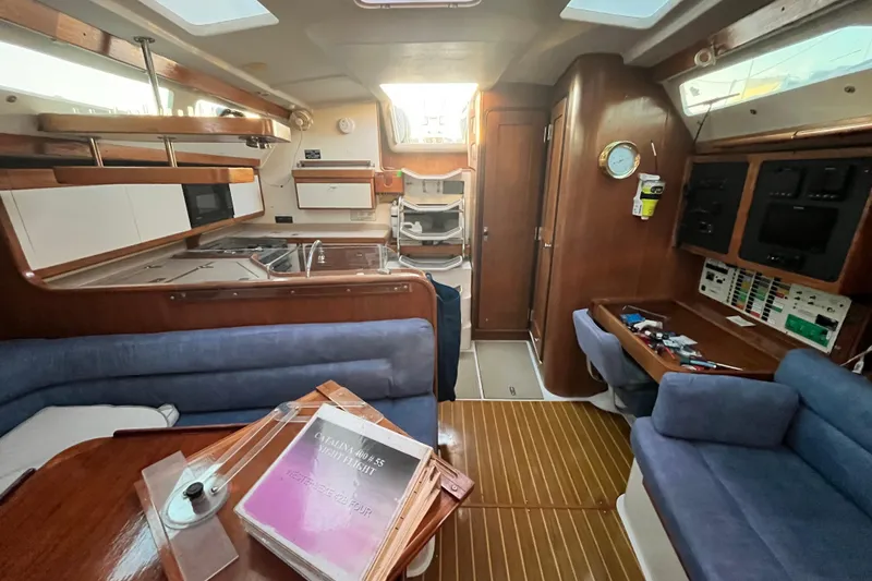 Slide: The Image of Interior of a 1996 Catalina 400 sailboat with cozy seating and navigation area. - 55
