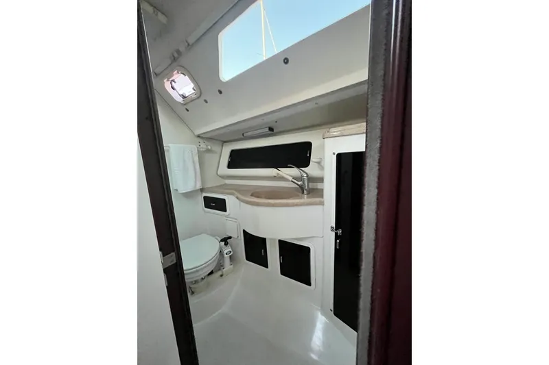 Slide: The Image of Interior of 1996 Catalina 400 sailboat bathroom with sink, toilet, and storage cabinets. - 61