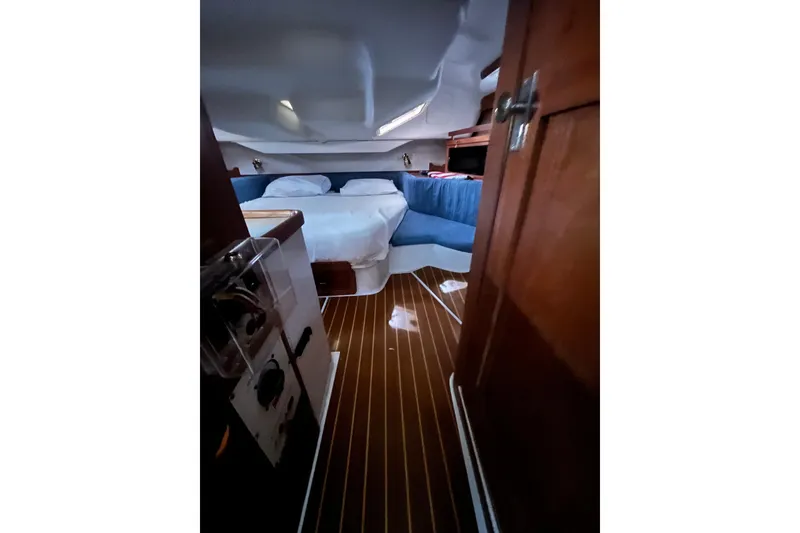 Slide: The Image of Interior of 1996 Catalina 400 yacht with cozy bed and wooden flooring. - 63