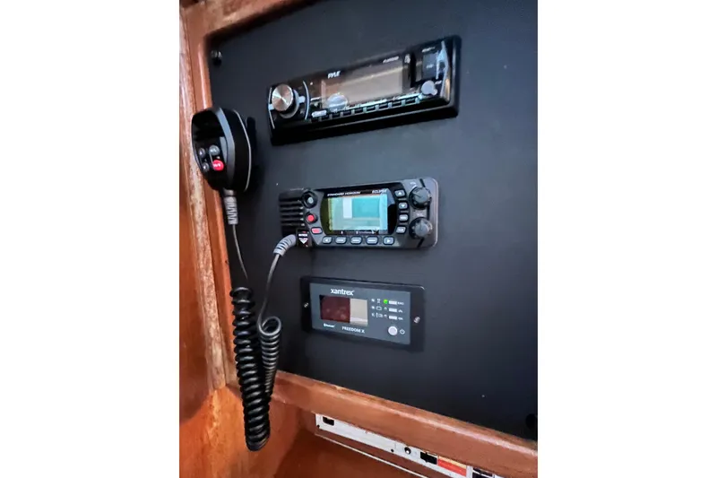 Slide: The Image of Control panel of a 1996 Catalina 400 sailboat with radio and communication equipment. - 65