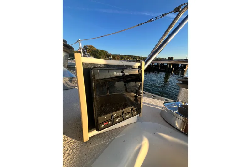 Slide: The Image of Catalina 400 sailboat cockpit with Raymarine navigation system, 1996 model, docked by the water. - 7