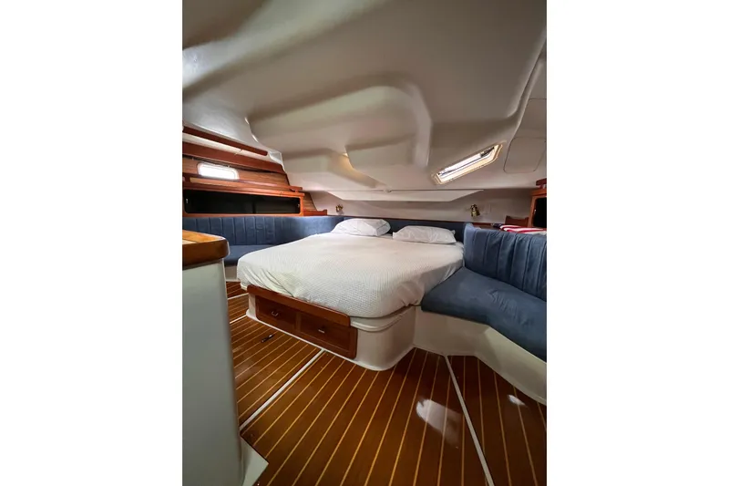 Slide: The Image of Cozy cabin interior of 1996 Catalina 400 sailboat with wooden flooring and comfortable bedding. - 77