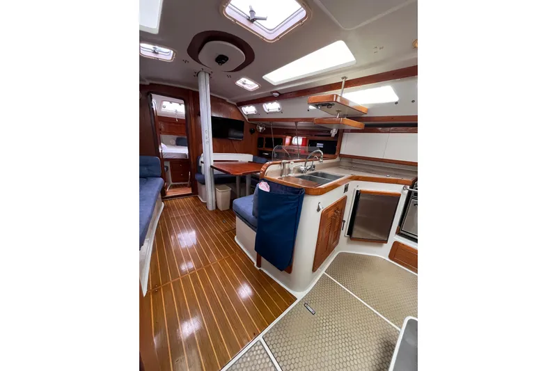 Slide: The Image of Interior of a 1996 Catalina 400 sailboat with wood flooring and modern amenities. - 81