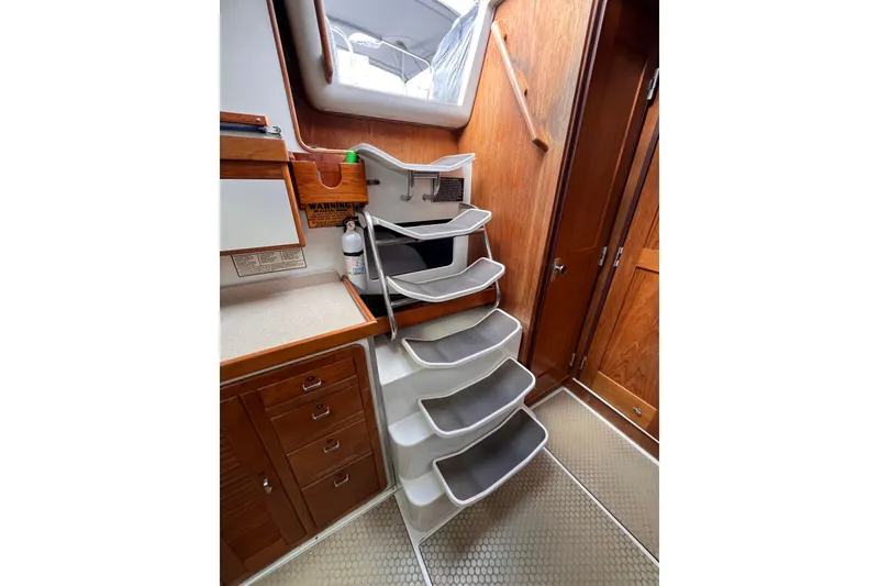 Slide: The Image of Interior of 1996 Catalina 400 sailboat with wooden cabinetry and staircase. - 83