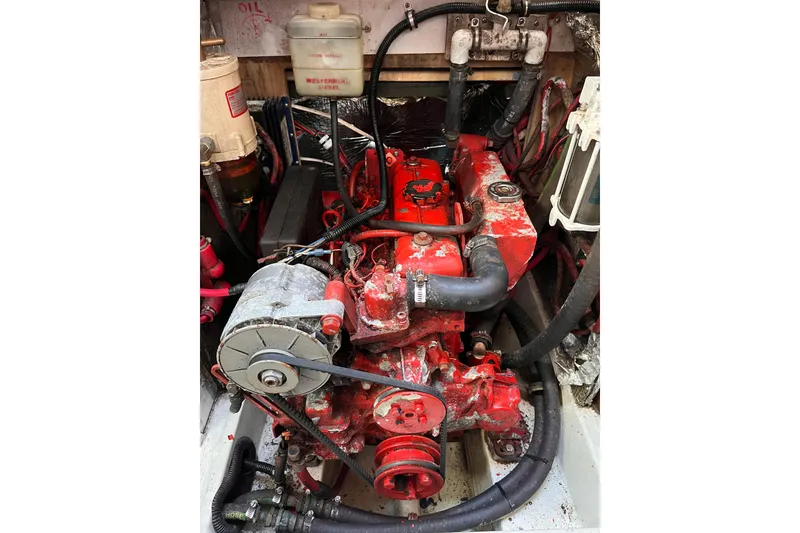 Slide: The Image of Engine compartment of a 1996 Catalina 400 sailboat, featuring a red Westerbeke diesel engine. - 84