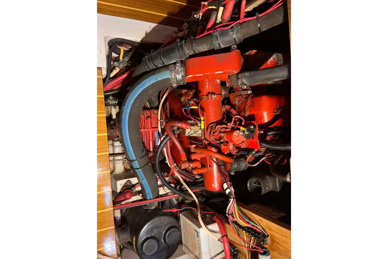 Slide: The Image of Engine compartment of a 1996 Catalina 400 sailboat, featuring red and blue components. - 87