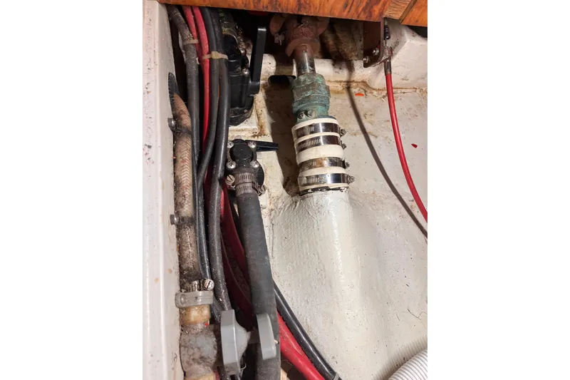 Slide: The Image of Engine compartment of a 1996 Catalina 400 sailboat, showing hoses and clamps. - 88