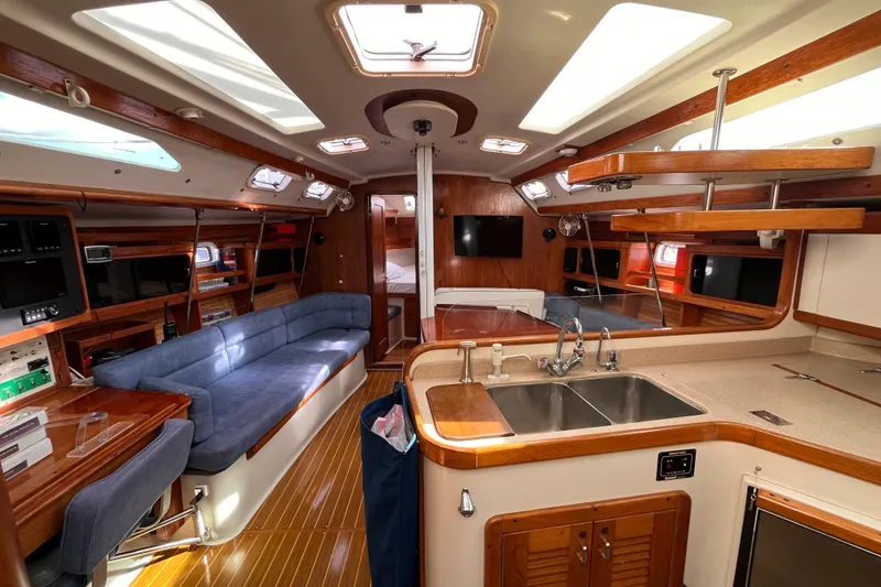 Slide: The Image of Interior of a 1996 Catalina 400 yacht with modern amenities and wooden finishes. - 93