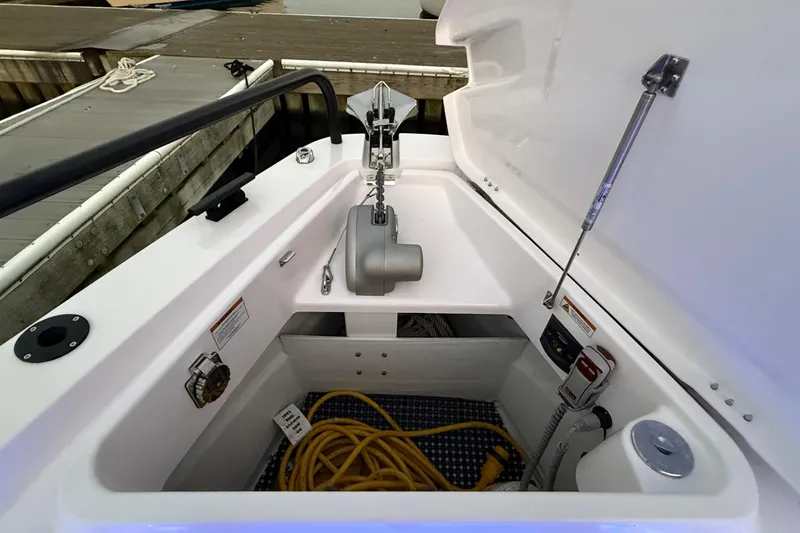 Slide: The Image of 2024 Axopar 37 boat storage compartment with anchor and yellow rope. - 10