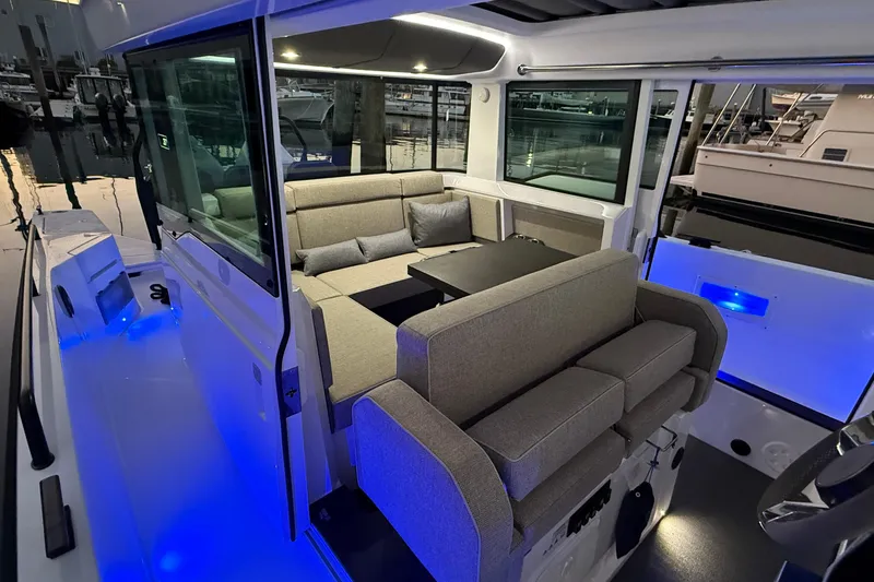 Slide: The Image of Luxurious interior of 2024 Axopar 37 boat with modern seating and ambient lighting. - 11