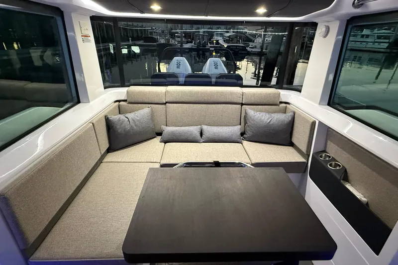 Slide: The Image of Luxurious interior of 2024 Axopar 37 boat with plush seating and table. - 12