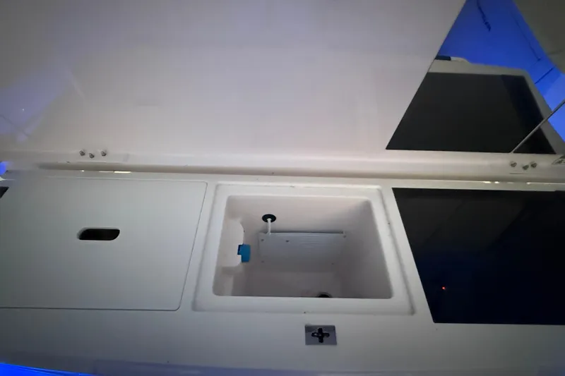 Slide: The Image of 2024 Axopar 37 boat interior storage compartment with sleek design and modern features. - 16