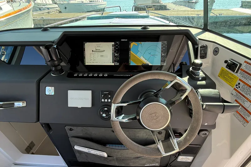 Slide: The Image of 2024 Axopar 37 helm with modern navigation displays and controls. - 20