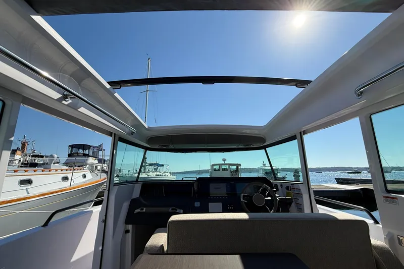 Slide: The Image of Interior view of 2024 Axopar 37 boat with open roof and sunny sky. - 22