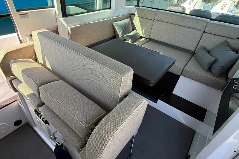 Slide: The Image of 2024 Axopar 37 interior with modern seating and table arrangement. - 24