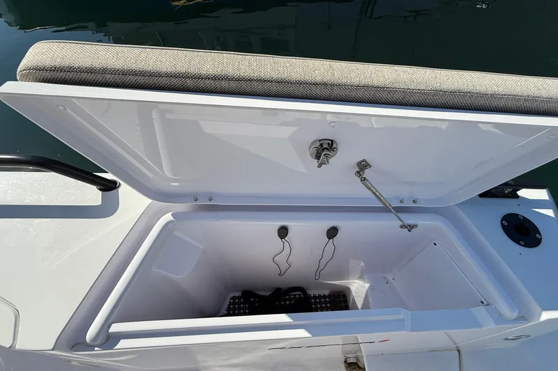 Slide: The Image of 2024 Axopar 37 boat storage compartment with open lid, showcasing interior space. - 35