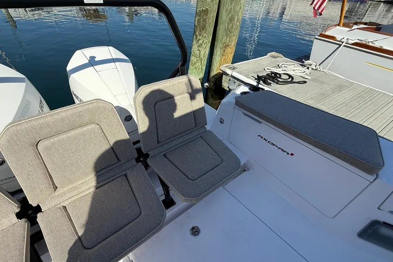 Slide: The Image of 2024 Axopar 37 boat interior with cushioned seats and outboard motors. - 36
