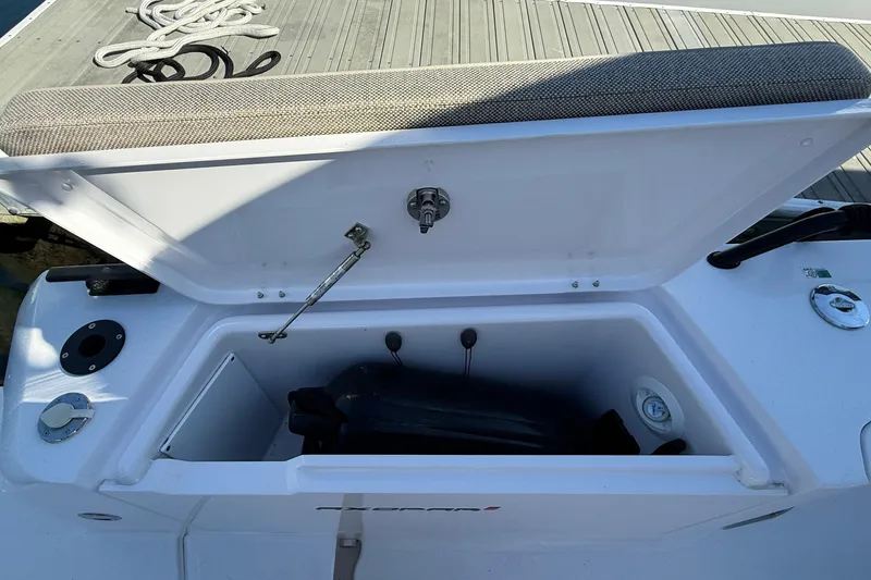 Slide: The Image of Open storage compartment on 2024 Axopar 37 boat, dockside view. - 37