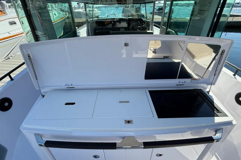 Slide: The Image of 2024 Axopar 37 boat with open deck storage and sleek design. - 41