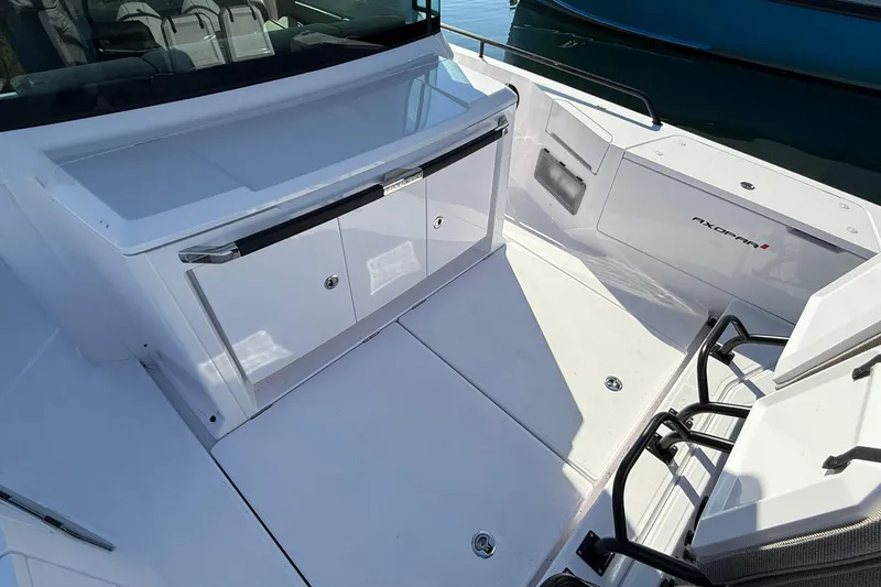 Slide: The Image of 2024 Axopar 37 boat deck with storage compartments and seating area. - 42