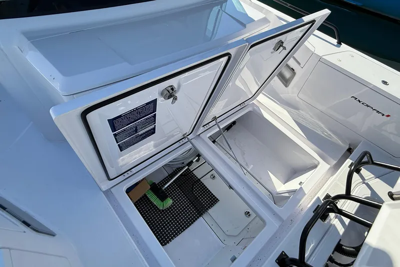 Slide: The Image of 2024 Axopar 37 boat storage compartment with open hatches and visible equipment. - 43