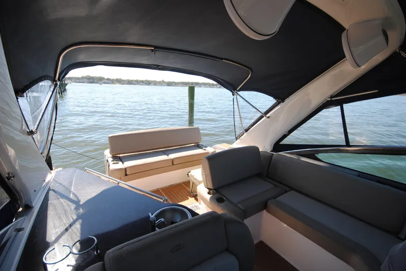 Slide: The Image of Interior view of 2015 Regal 32 Express boat with seating and water backdrop. - 11