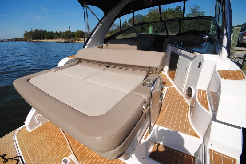 Slide: The Image of 2015 Regal 32 Express boat with spacious seating and sleek design on a sunny day. - 12