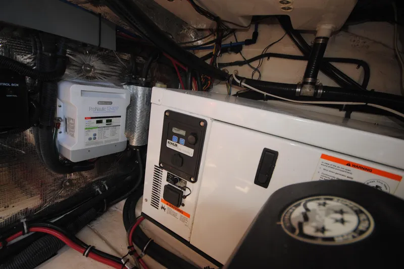 Slide: The Image of Engine room of a 2015 Regal 32 Express boat with electrical components and wiring. - 23