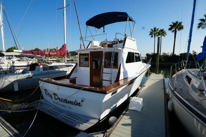 The Image of 1972 Viking 33 boat docked at marina, sunny day, palm trees in background. - 0