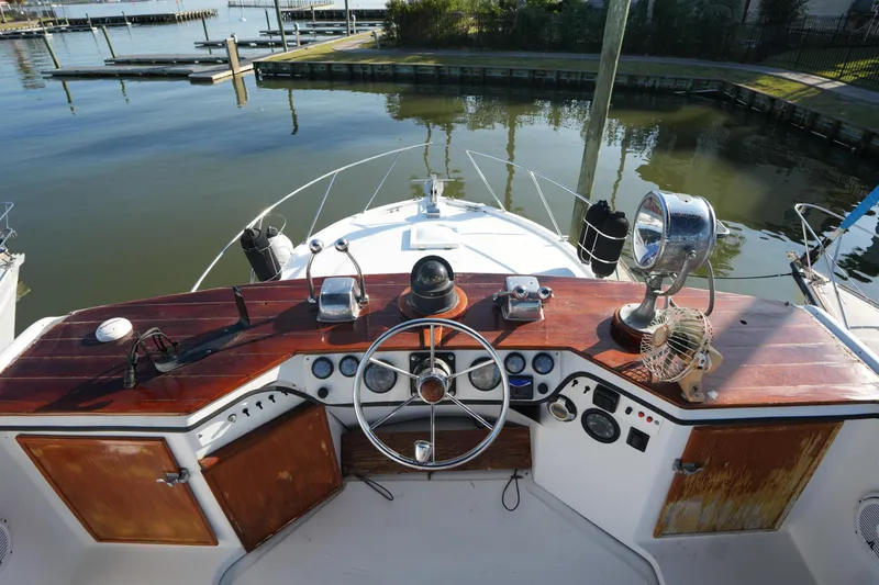 Slide: The Image of 1972 Viking 33 boat helm with wooden dashboard, steering wheel, and navigational instruments. - 10
