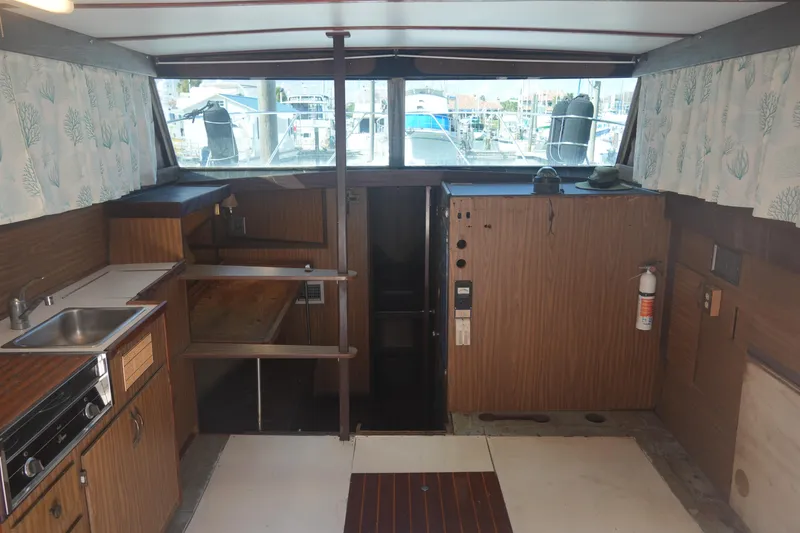 Slide: The Image of 1972 Viking 33 boat interior with kitchenette, wood paneling, and nautical decor. - 13