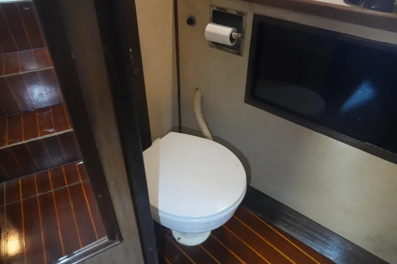 Slide: The Image of 1972 Viking 33 boat bathroom with wooden flooring and compact toilet. - 19