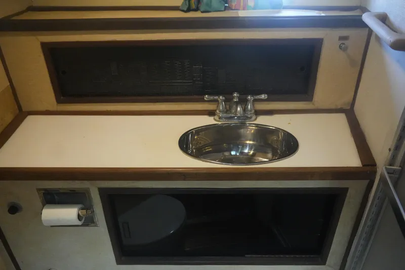 Slide: The Image of 1972 Viking 33 bathroom sink with chrome faucet and storage compartments. - 20