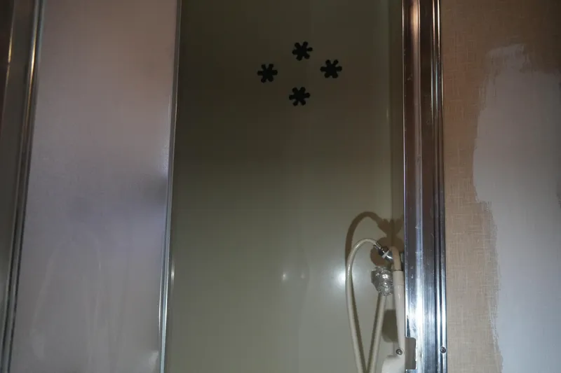 Slide: The Image of Shower area in a 1972 Viking 33, featuring a handheld showerhead. - 21