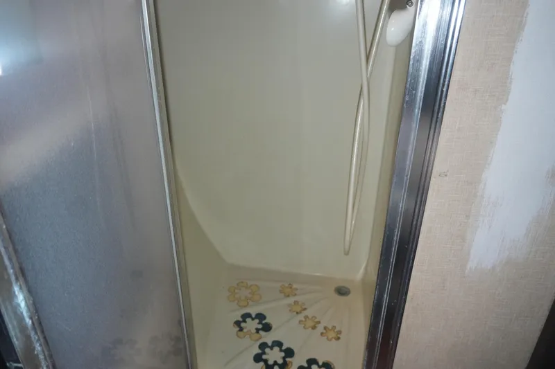 Slide: The Image of Shower area in a 1972 Viking 33 with floral decals and sliding door. - 22