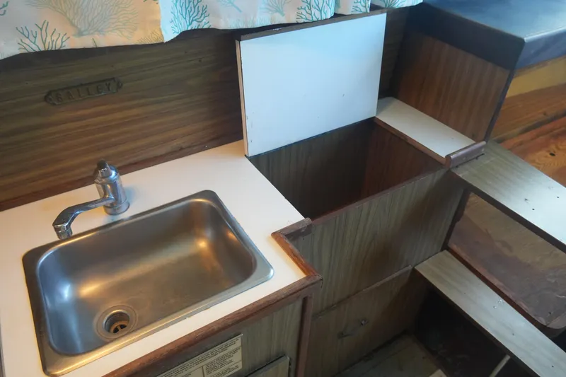Slide: The Image of 1972 Viking 33 boat galley with sink and wooden cabinetry. - 24