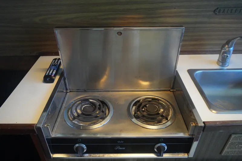 Slide: The Image of 1972 Viking 33 stove with two burners, stainless steel finish, next to a sink. - 25