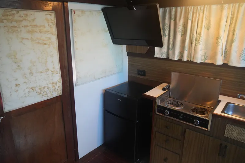 Slide: The Image of 1972 Viking 33 interior kitchen with stove, fridge, and vintage decor. - 26