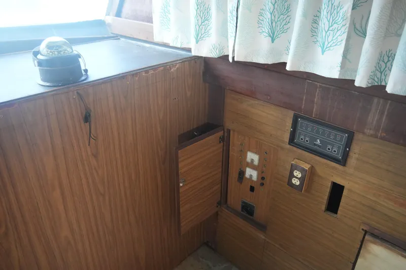 Slide: The Image of 1972 Viking 33 boat interior with control panel, compass, and nautical-themed curtains. - 27