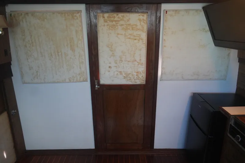 Slide: The Image of Interior of a 1972 Viking 33 boat with wooden door and vintage decor. - 29