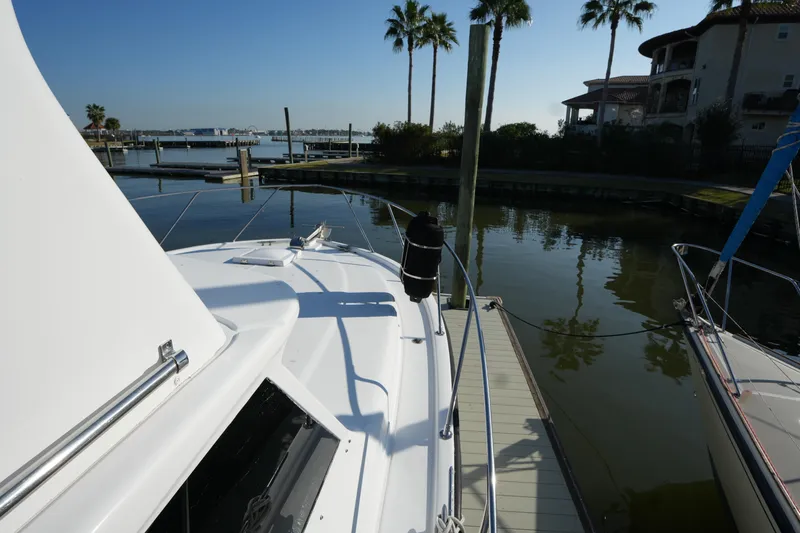 Slide: The Image of 1972 Viking 33 boat docked at marina with palm trees and waterfront view. - 5