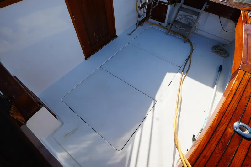 Slide: The Image of 1972 Viking 33 boat deck with wooden accents and storage compartments. - 7