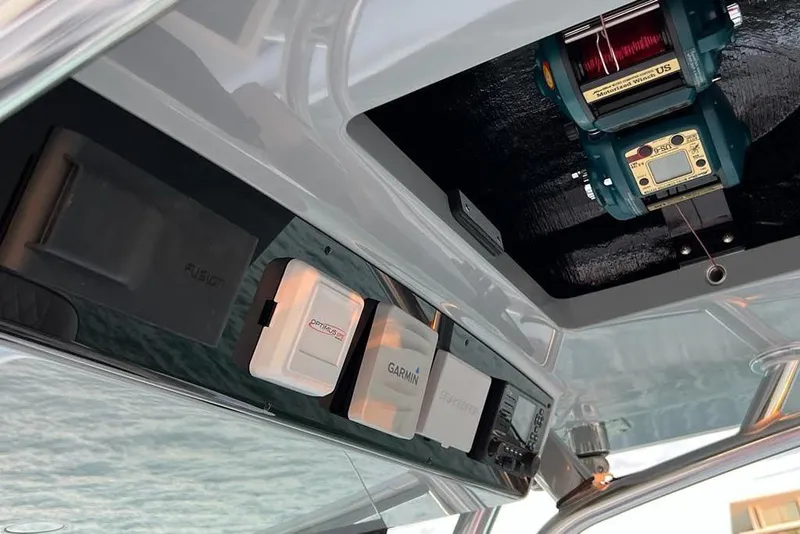 Slide: The Image of 2023 Valhalla Boatworks V-37 electronics panel with Garmin and Fusion systems. - 14