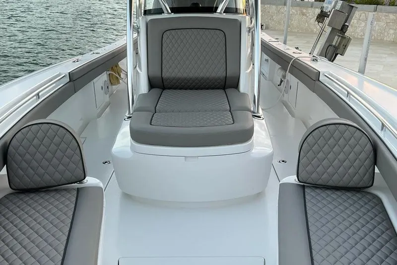 Slide: The Image of 2023 Valhalla Boatworks V-37 interior with gray quilted seating, dockside view. - 5