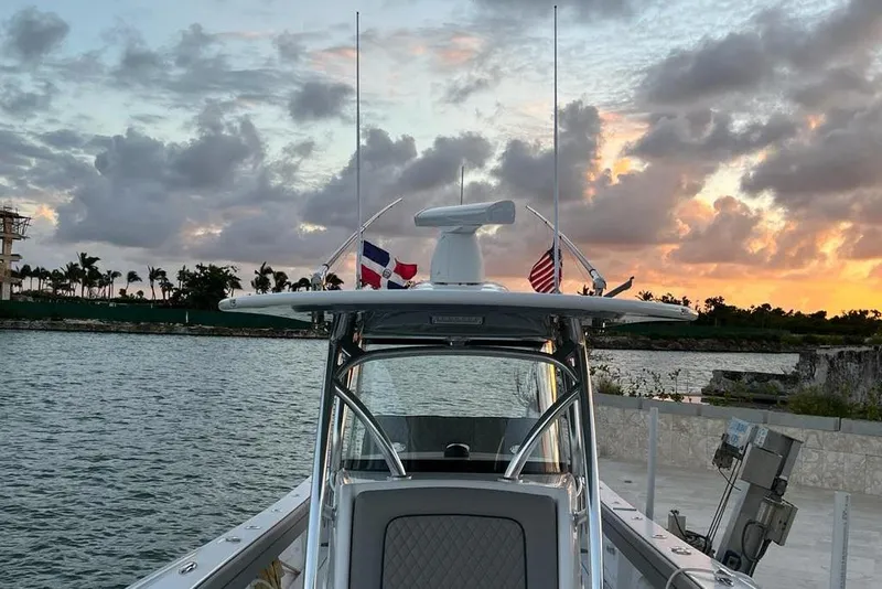 Slide: The Image of 2023 Valhalla Boatworks V-37 at sunset, featuring flags and scenic waterfront. - 6