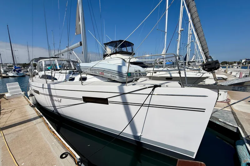 Slide: The Image of 2020 Catalina 425 sailboat docked at marina under clear blue sky. - 0