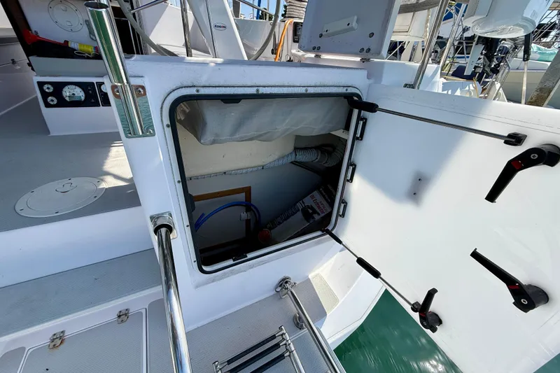 Slide: The Image of Open hatch on 2020 Catalina 425 sailboat, revealing storage compartment and equipment. - 12