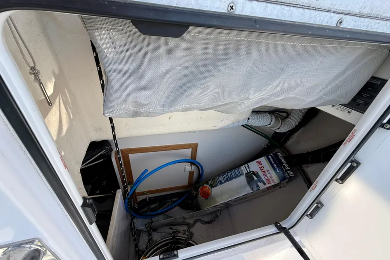 Slide: The Image of Storage compartment in a 2020 Catalina 425 sailboat with various equipment and tools. - 13